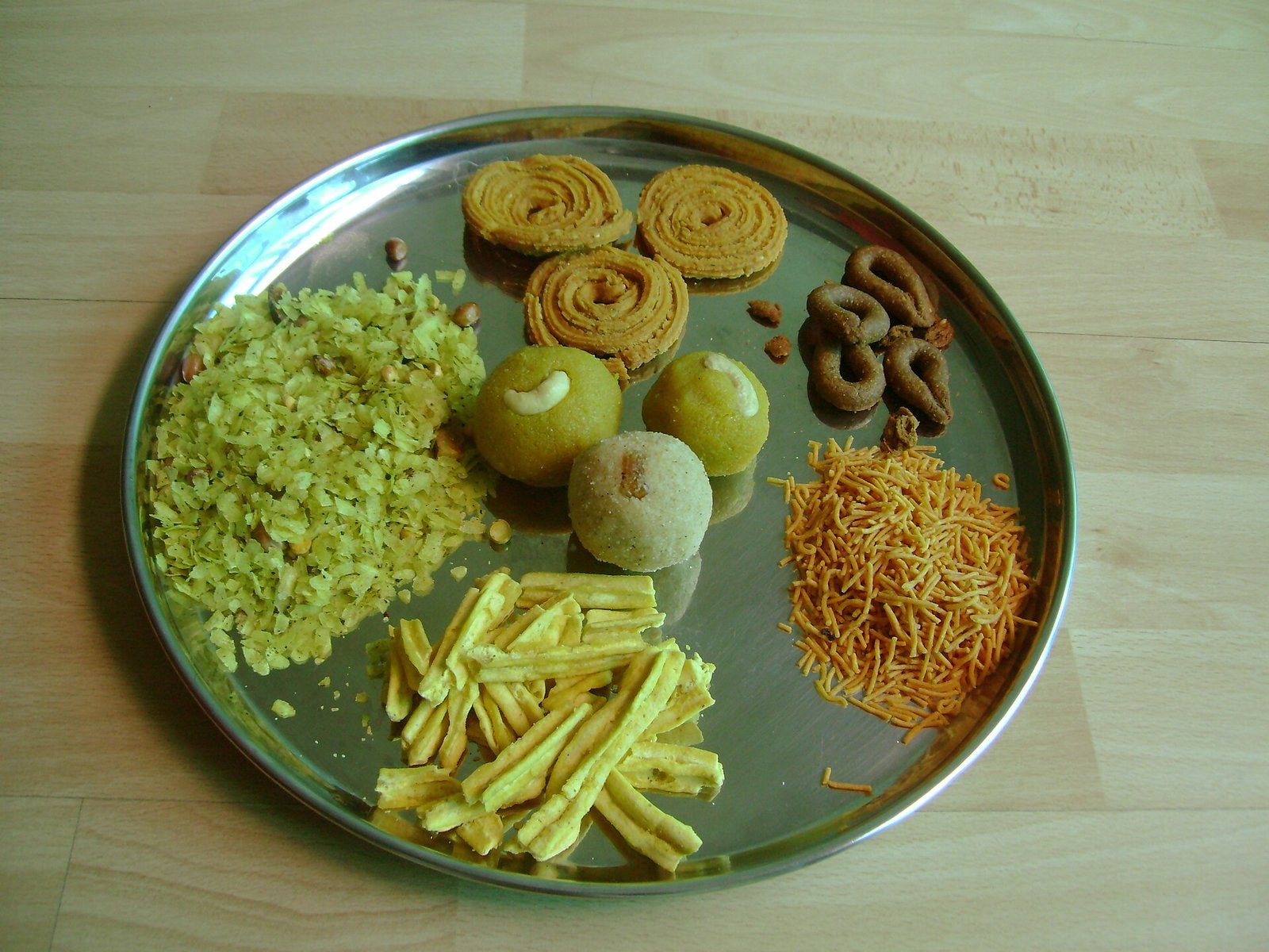 A full Diwali faral spread laid out on a decorated table