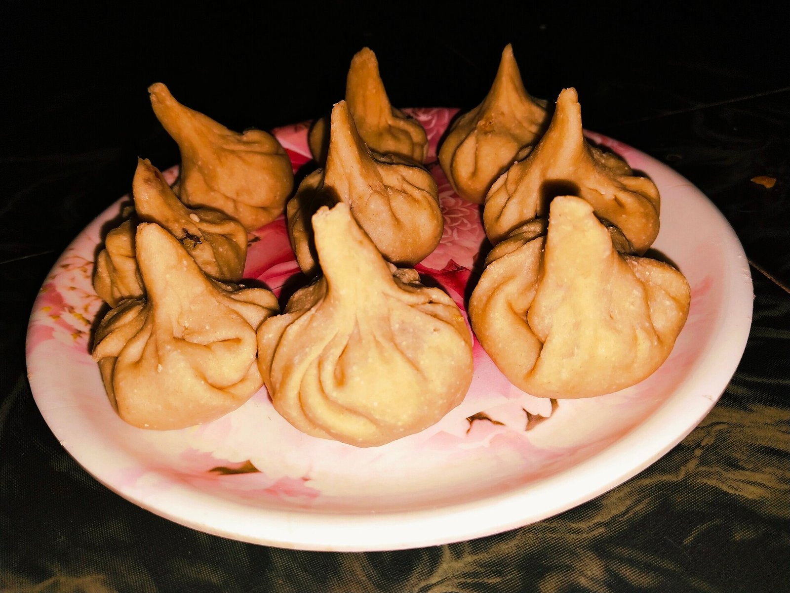 Pleated modak filled with coconut and jaggery