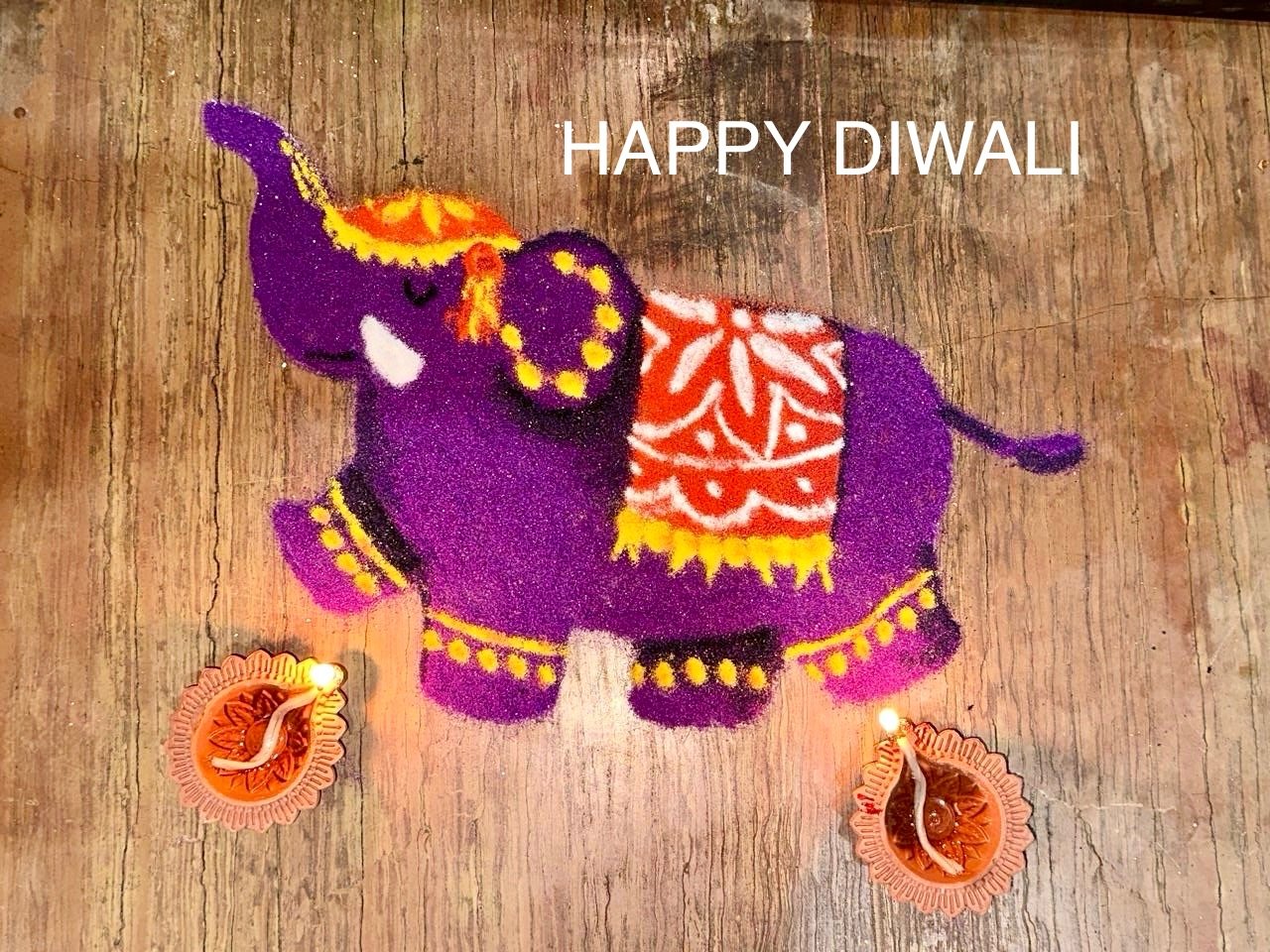 Diyas glowing on a rangoli drawn for Diwali
